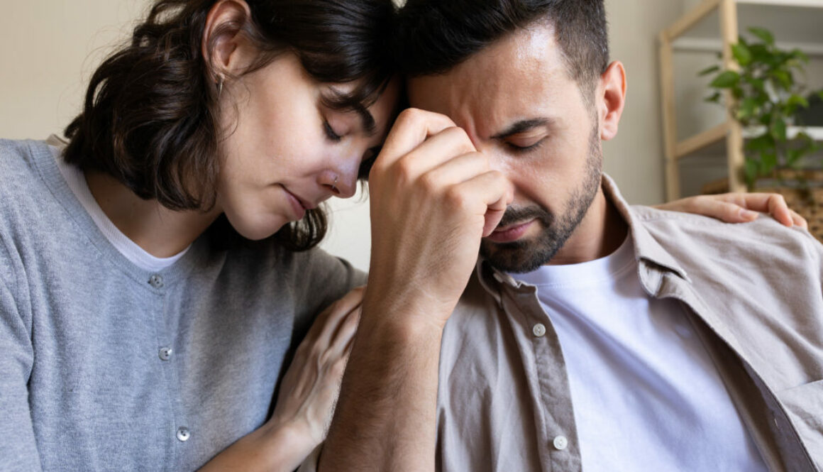 Close up of woman comforting husband.